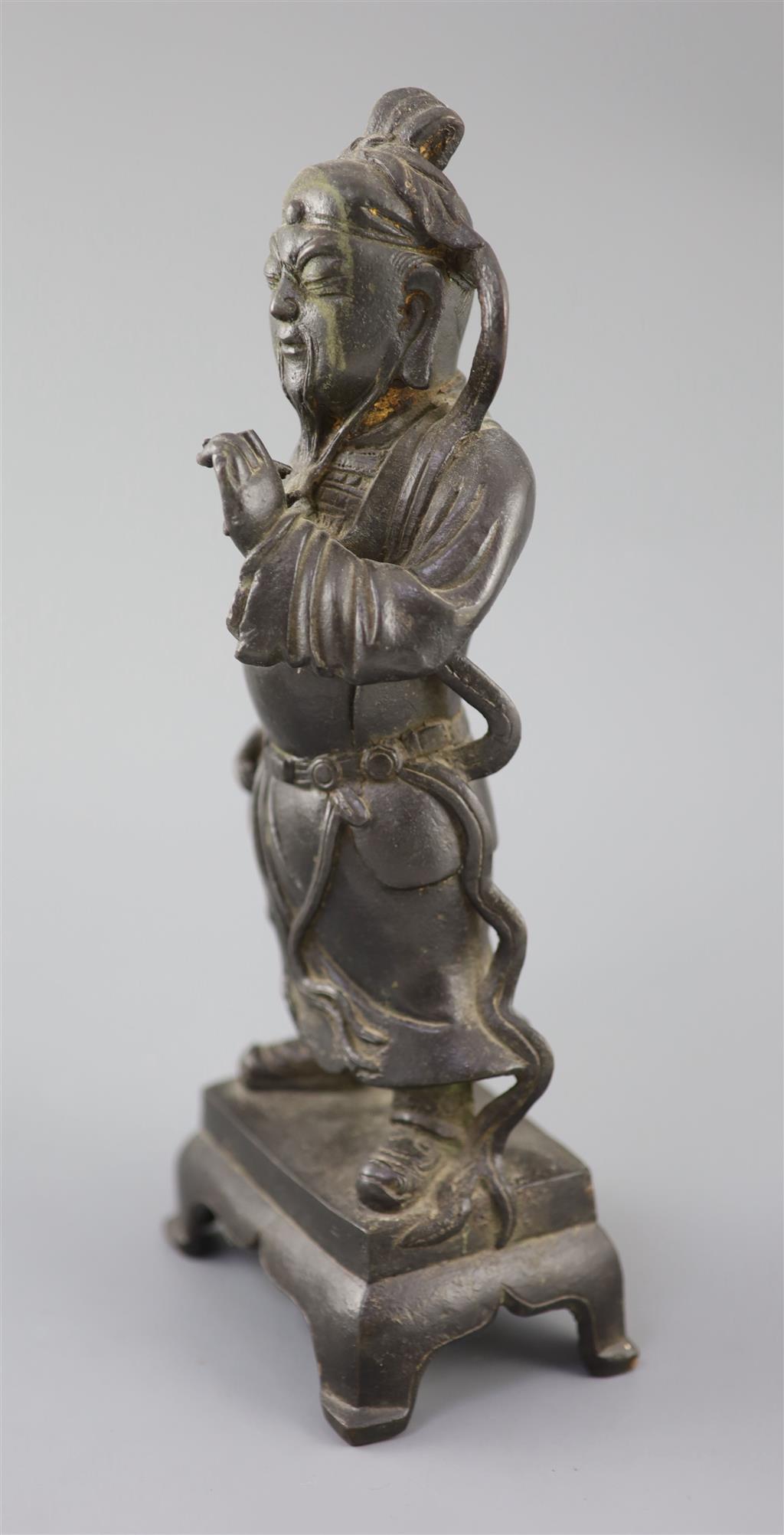 A Chinese bronze standing figure of Guandi, 16th/17th century, 31cm high, small losses